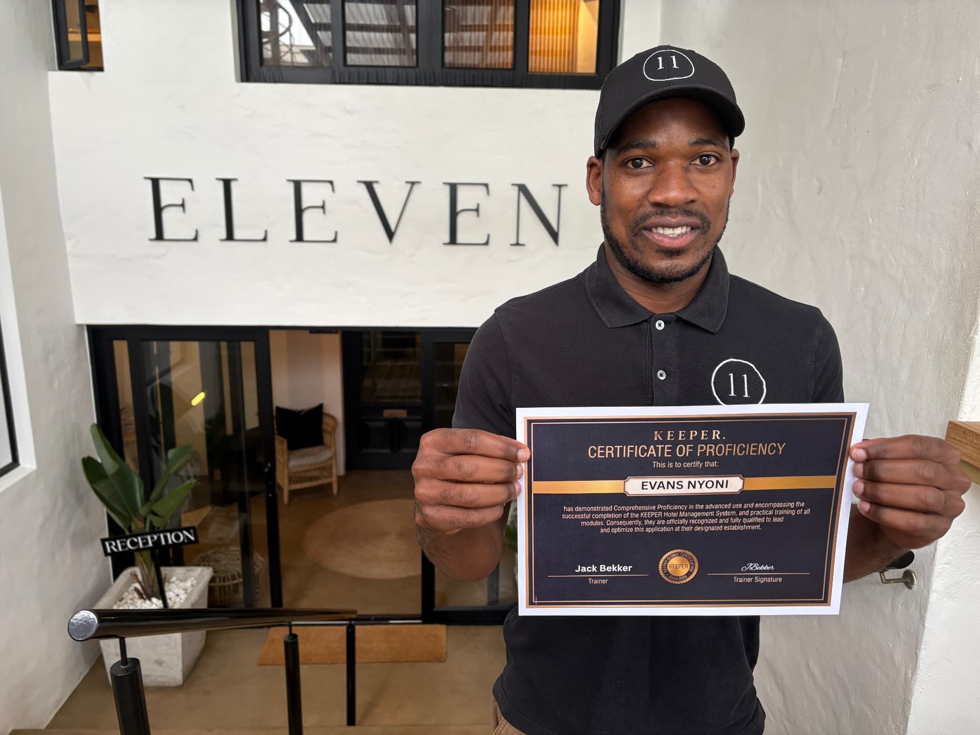 Evans Nyoni holding his Keeper Certificate of Proficiency outside Eleven Hotel